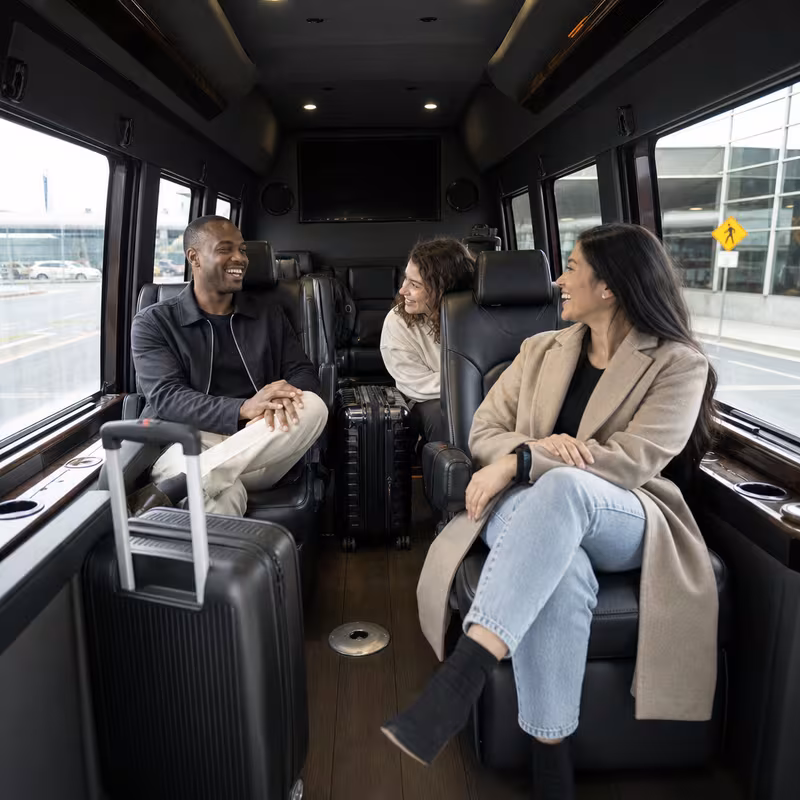 Passengers loading luggage while boarding an Staten Island group shuttle