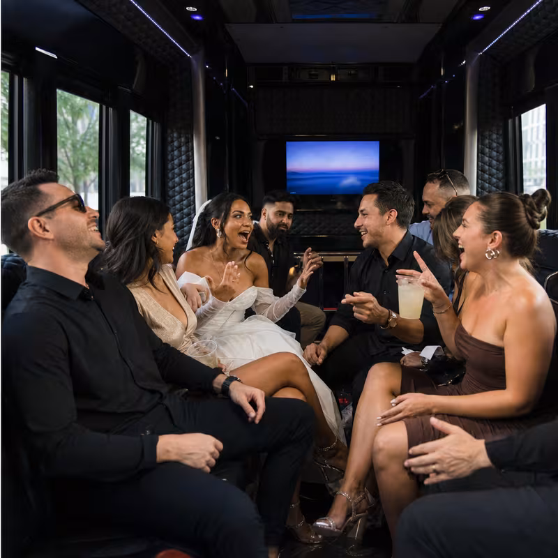 Party bus interior with wraparound leather seating and LED lighting in Staten Island