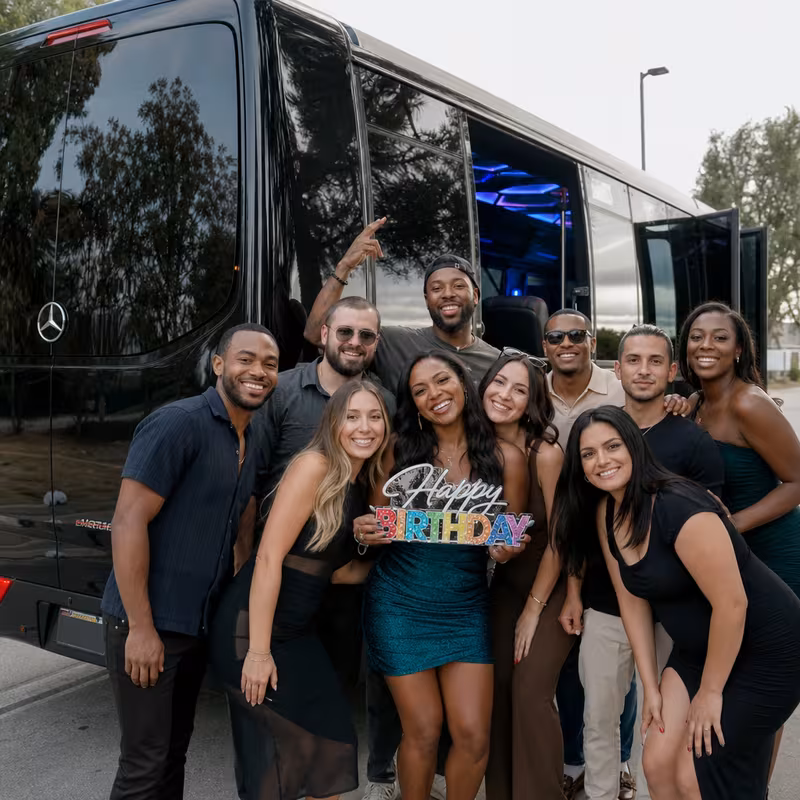 Group boarding a white charter bus for Birthday Transportation transportation in Staten Island