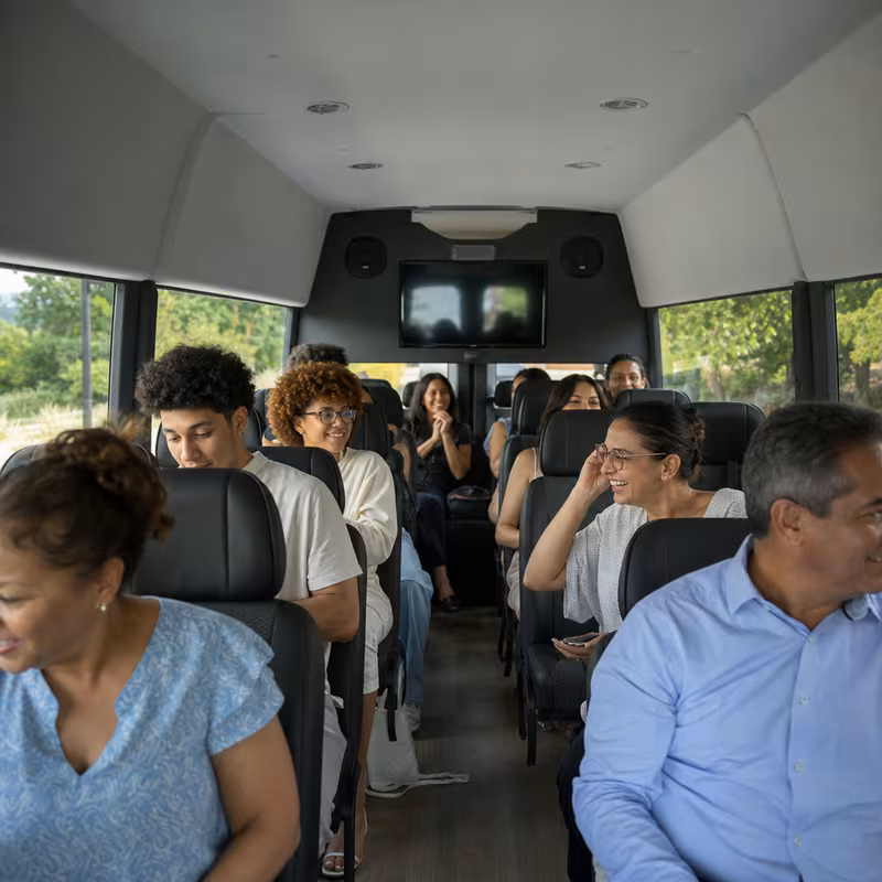 Group boarding a white charter bus for Private Event Transportation transportation in Staten Island