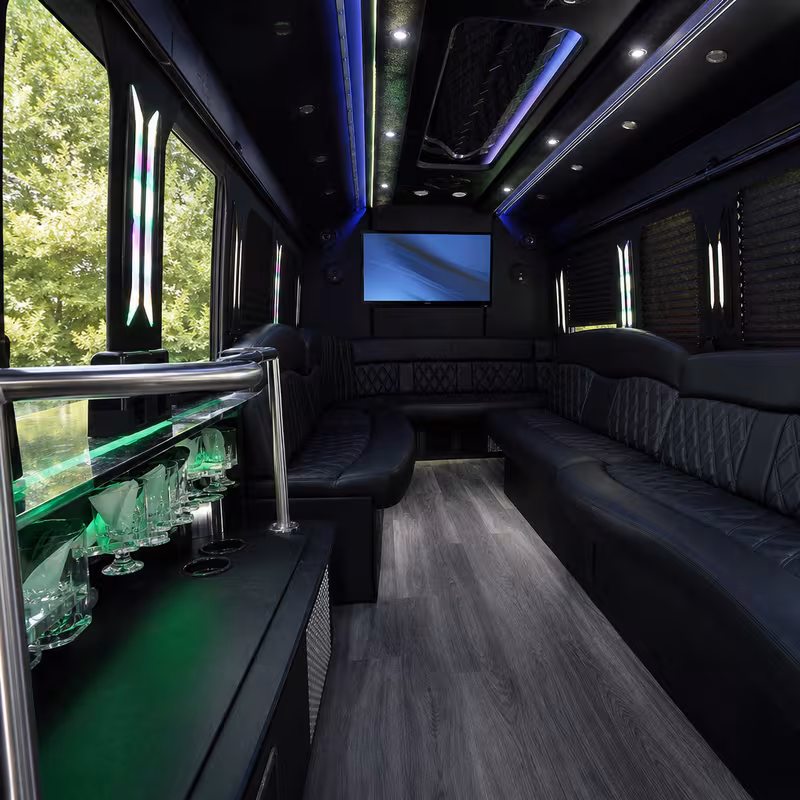 Party bus interior with wraparound leather seating and LED lighting in Staten Island