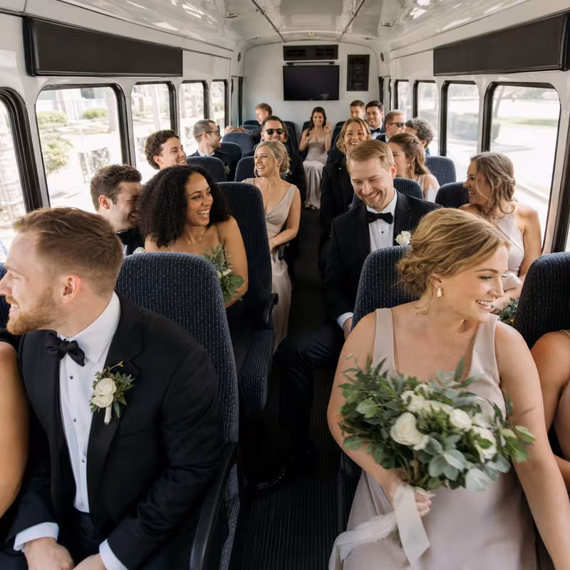 Group boarding a white charter bus for Wedding Transportation transportation in Staten Island