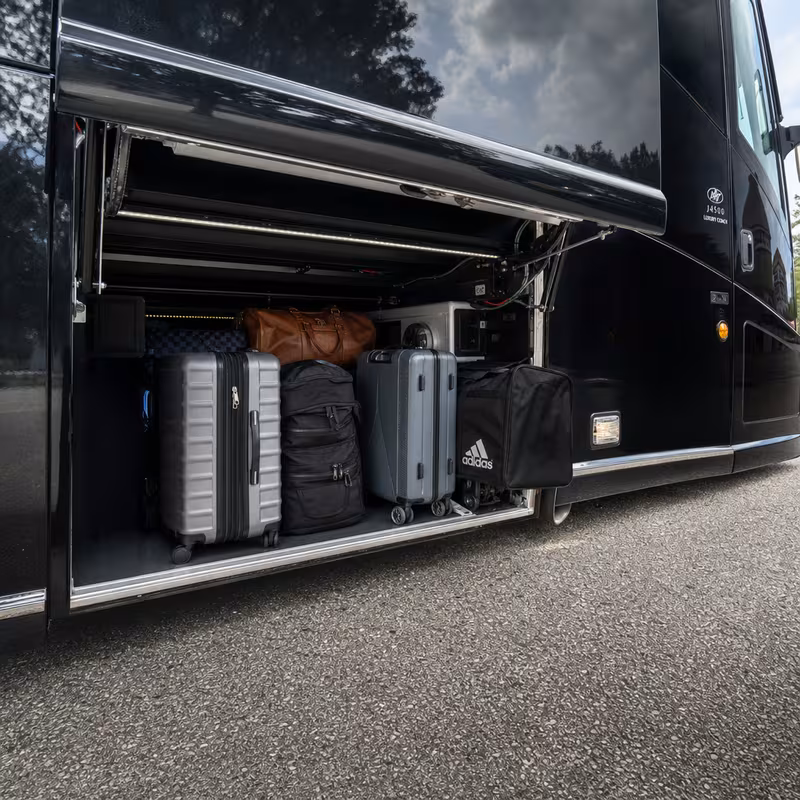 Party bus interior with wraparound leather seating and LED lighting in Staten Island