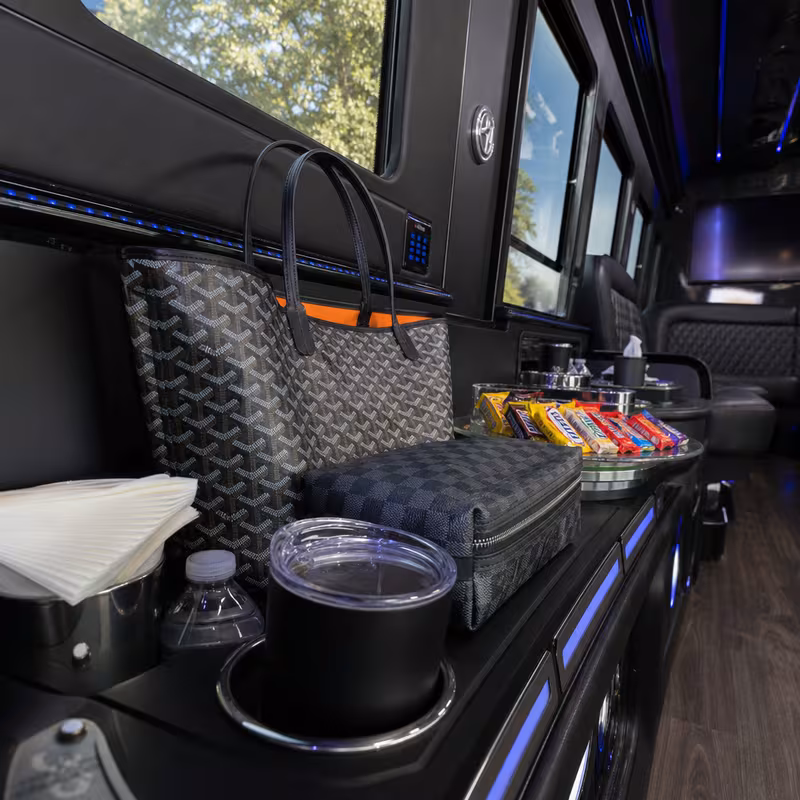 Party bus interior with wraparound leather seating and LED lighting in Staten Island
